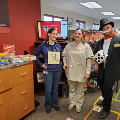 Members of College Relations dressed in a board game theme for Halloween.