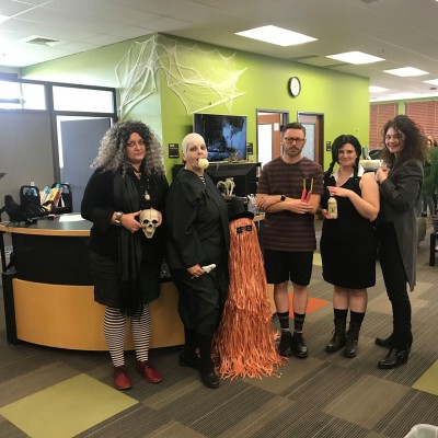 Members of the Library dressed in an Adams Family theme for Halloween. 