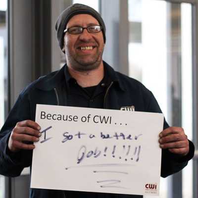 Students holding up their Because of CWI signs