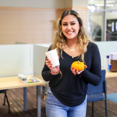 CWI Student holding a pumpkin