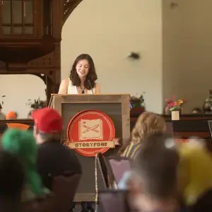 Person stands behind Storyfort podium