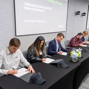 Group of people signing a paper
