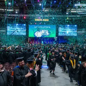 Confetti falls on the crowd at commencement
