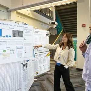 Student presenting poster to judge