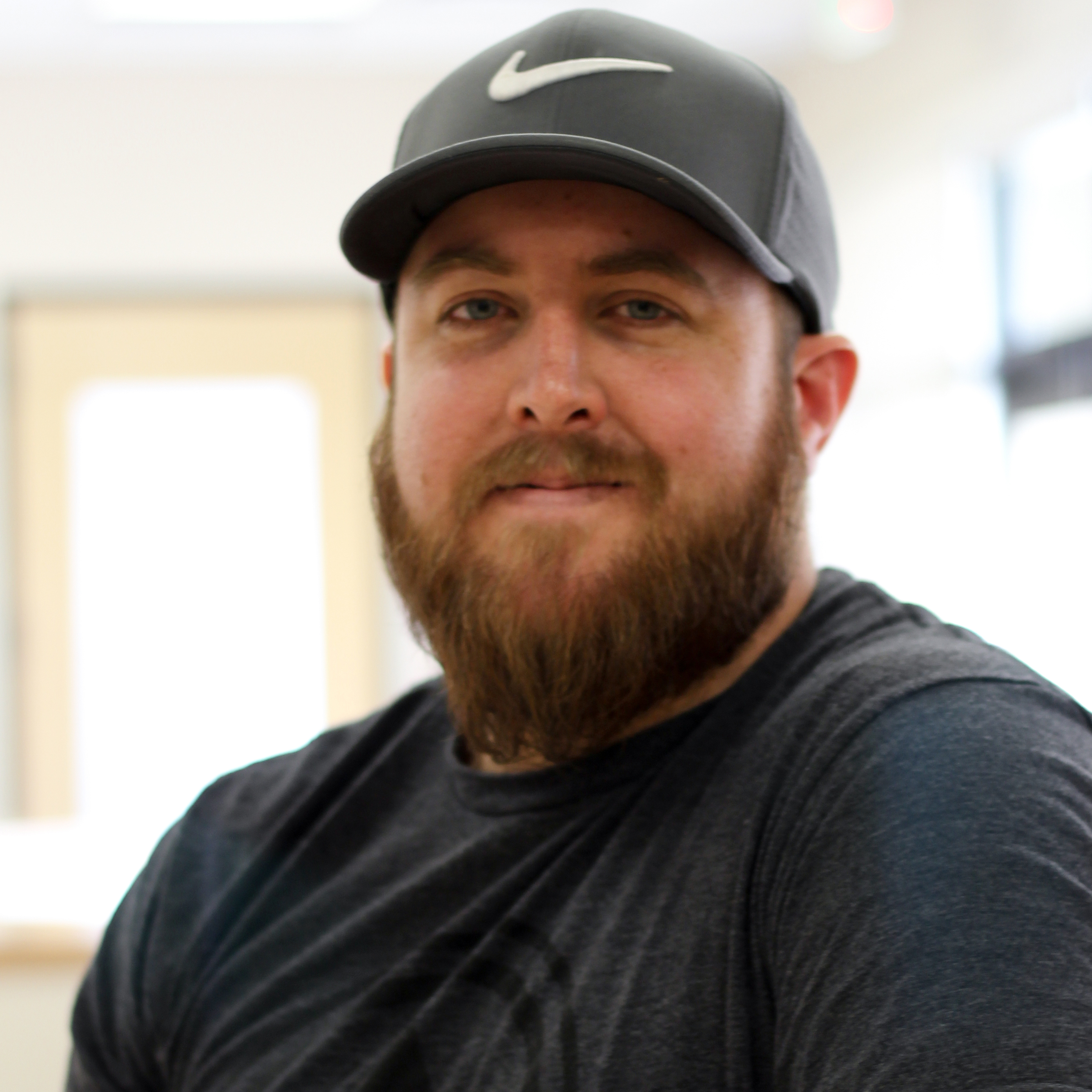 Headshot of Scott Keene wearing a gray Nike hat and dark shirt.