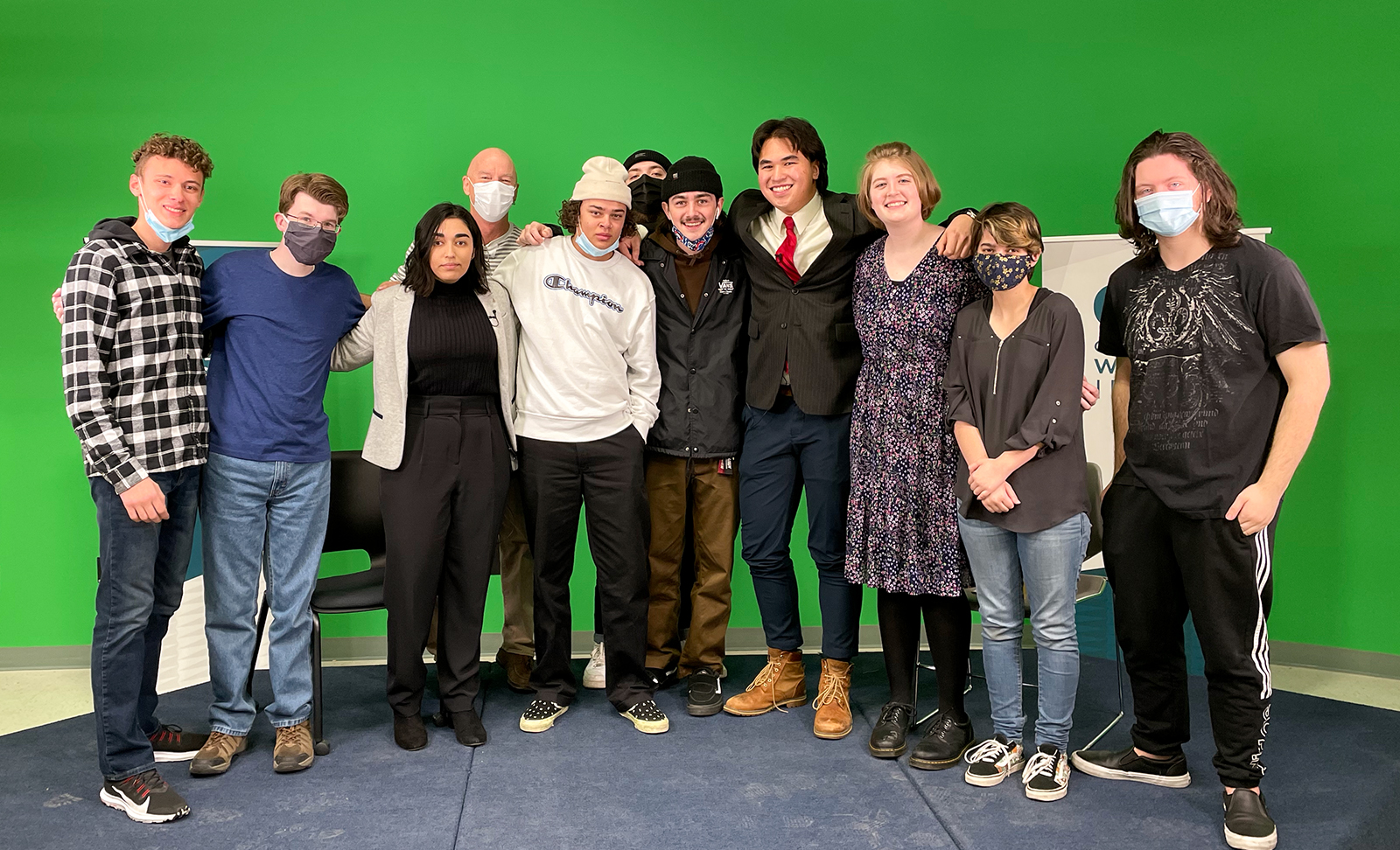 Marketing Communications students posing in front of green screen in CWI media lab