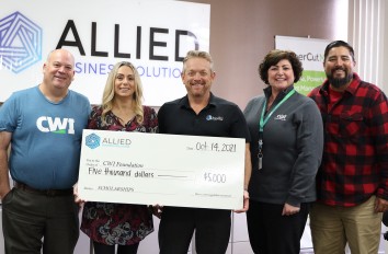 Foundation staff recieving check from Allied Business Solutions