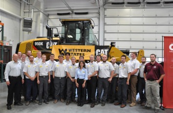 Western States Cat student group photo with Cat machinery in lab.
