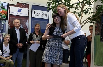 Female student being awarded the Emerging Scholars Award