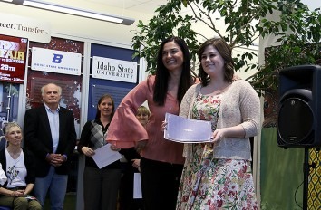 Female student being awarded the Emerging Scholars Award