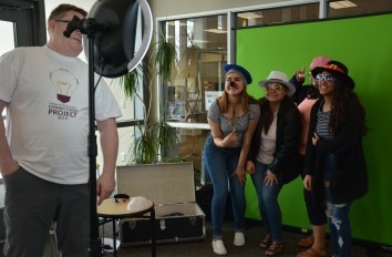 Students with props in photo booth