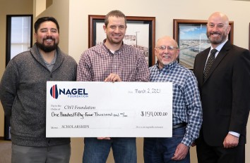 Nagel Foundation representative with CWI Foundation Board members with a scholarship donation check