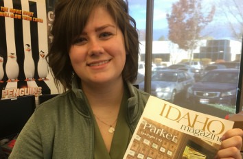 Media Arts student holding a copy of Idaho Magazine.
