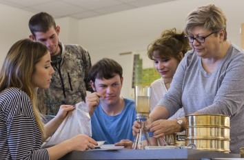 Students conducting a lab experiment at a table.