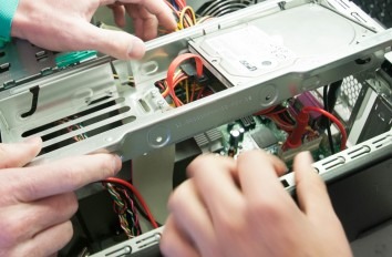 Students studying the inside of a desktop computer