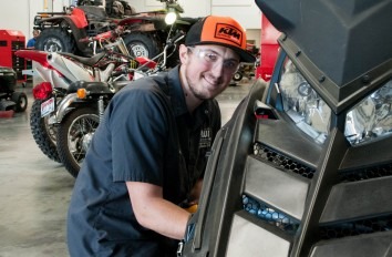 Powersports student working on a snowmobile