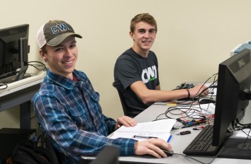 Two students in classroom working on desktop computers