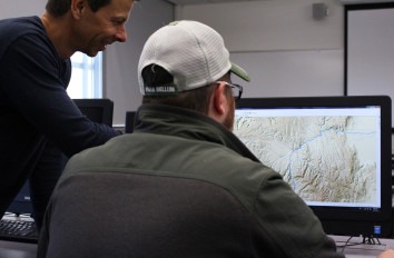 Geographic Information Systems students looking at map on computer.