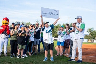 Hawks mascot with CWI students and employees on the field at CWI Night at the Hawks