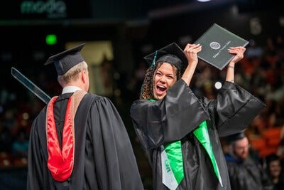 Graduate receiving diploma on stage