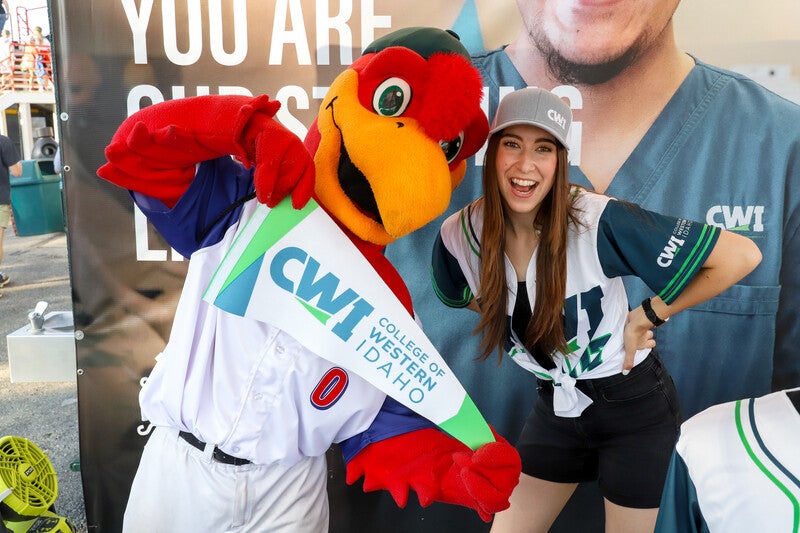 Hawks mascot with a CWI employee holding a CWI banner