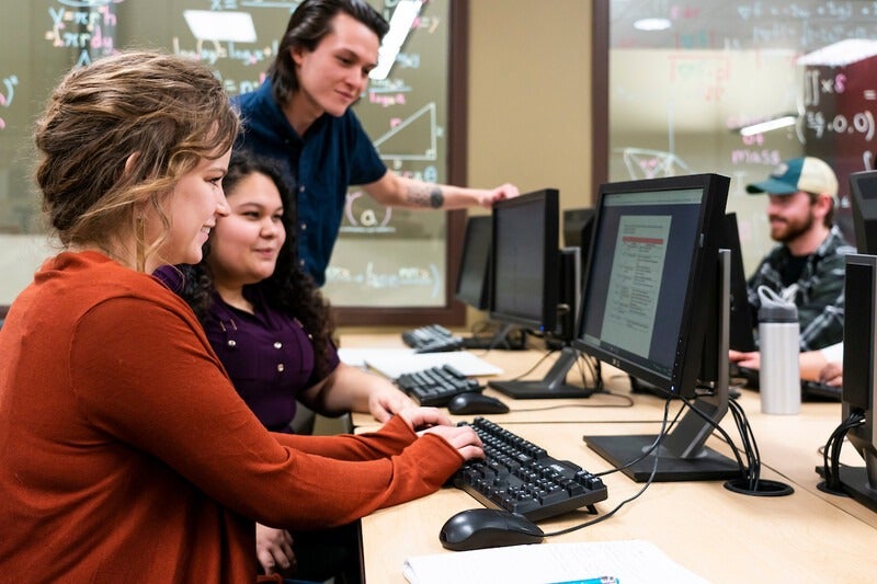 Students working at computers in a classroom
