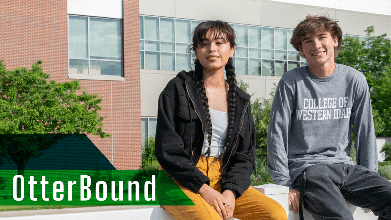 Two students sitting outside CWI building