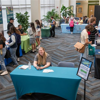 People visiting different booths and tables