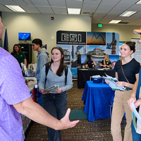 Group of people talking in middle of room