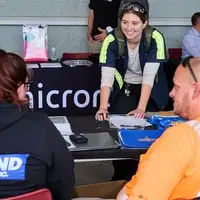 Student speaks with employers at table