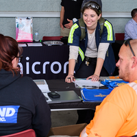 Student speaks with employers at table