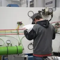 Person reading through papers in front of tank