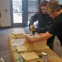 Students building kestrel boxes