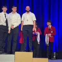 Students stand on the first and second podium