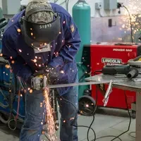 Student working using chop saw to cut metal