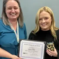 Two people standing together holding a certificate