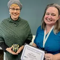 Two people standing together holding a certificate