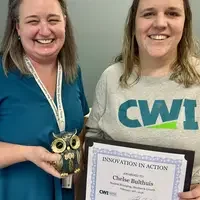 Two people standing together holding a certificate
