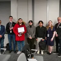 Graduates stand with their instructors
