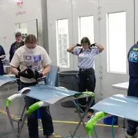 Students working in the Collison Repair competition