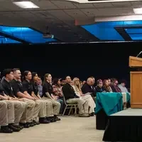 Stacy Mowry speaking to graduates and audience