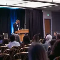 Gordon Jones behind podium speaking to audience