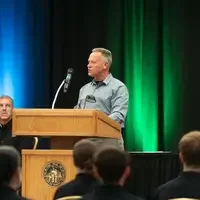 Will Stoy speaking behind podium