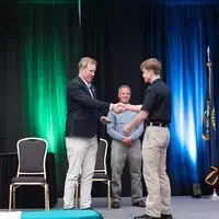 Jones shaking hands with a graduate