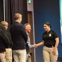 Graduate walking across the stage, shaking hands