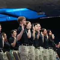 Graduates raising hand and reciting oath