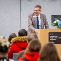 Ashley Smith speaking at the podium
