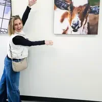 Stephanie Taylor stands next to photo