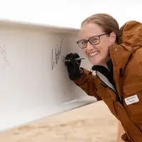 Person signing a beam