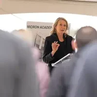 April Arnzen chatting at podium